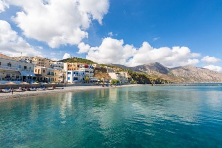 landscape sea surrounded by mountains buildings beaches blue cloudy sky greece 181624 7981
